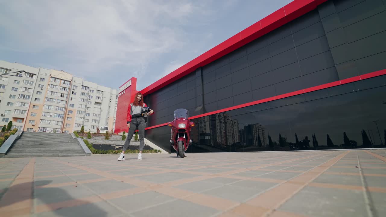 Girl motorcyclist in jacket. Sexy fashion female biker girl with motorcycle helmet