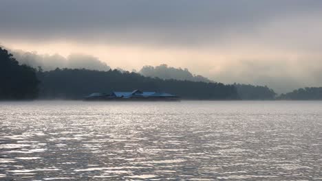 foggy river with distant mountains and buildings