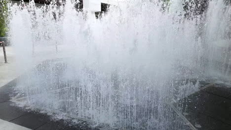 Rhythmic-cascading-patterns-of-waters-shooting-up-and-going-down-in-a-fountain-at-a-community-mall-in-Bangkok,-Thailand