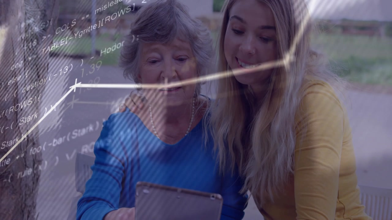 Granddaughter guiding grandmother tapping tablet generating data visuals in tech lesson