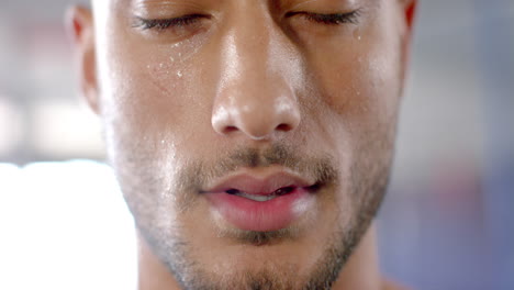 working out intensely at gym, man sweating and focusing on exercise
