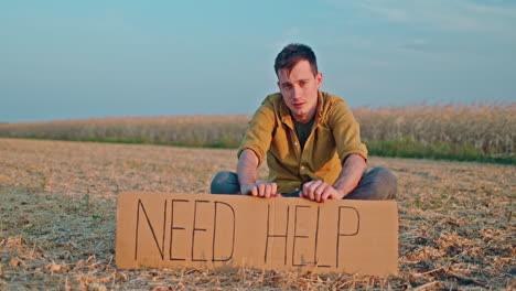 man in a field asking for help