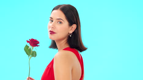 face, rose and woman in studio on blue background