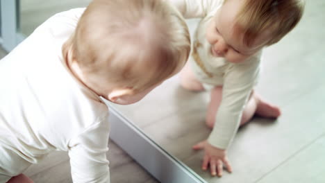 Beautiful-baby-looking-in-mirror