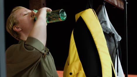 Woman-drinking-water-indoors