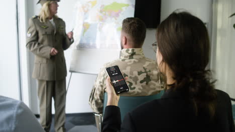 woman explaining situation with a map at the conference