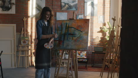 woman painting abstract art in an art studio