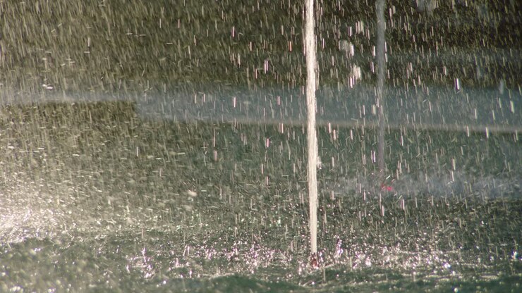 Water droplets texture created by fountain drops falling and splashing on surface