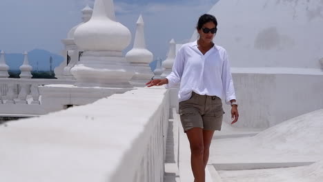 White-scene:-Woman-walks-along-roof-top-balustrade-of-Leon-Cathedral