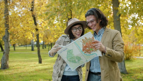 couple exploring a city park with a map