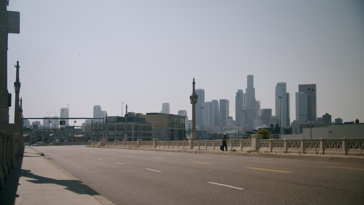 Cityscape view from a bridge with a person walking