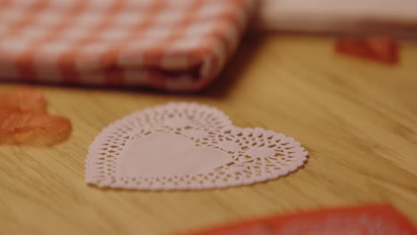 pink heart-shaped doily on wooden table