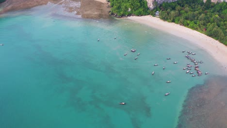 Drone shot of Railay with jungle near the beach and boats docked