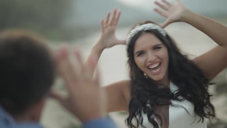 Wedding-couple-standing-near-mountain-river.-Groom-and-bride-making-faces