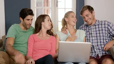 happy couples using laptop together