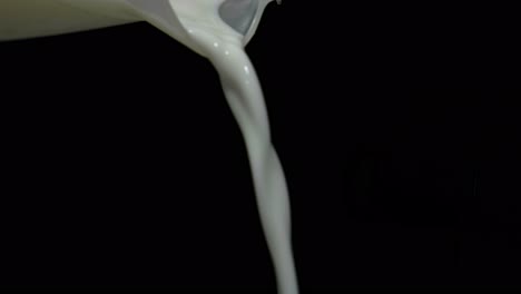 milk is poured from jug to blue bowl