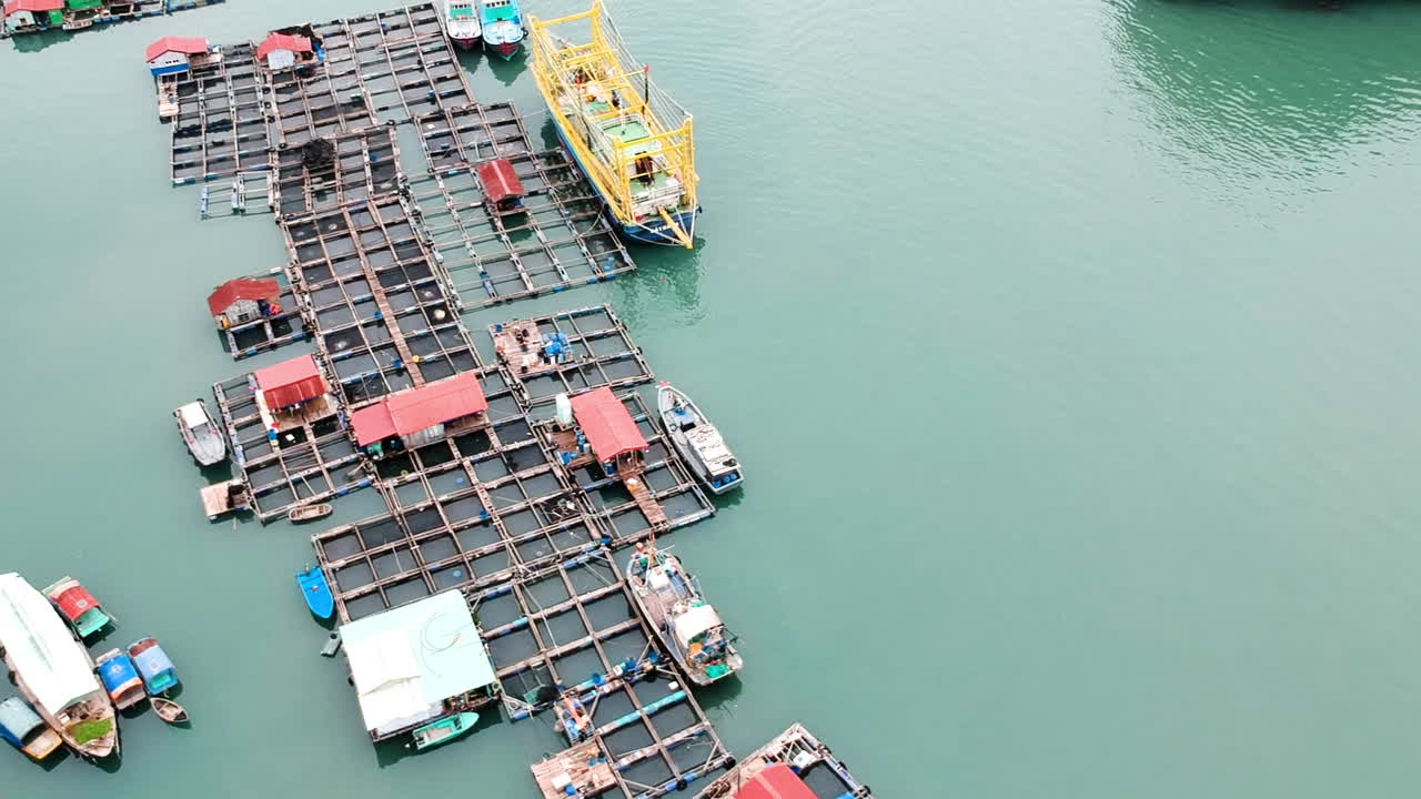 halong bay vietnam barcos de pesca y fisher viallage drone video sobre el mar y la montaña de pilares de piedra caliza verde