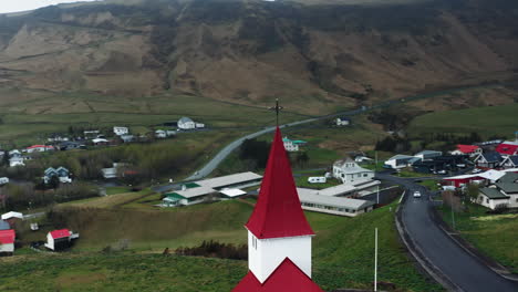 Aerial-drone-shot-of-local-Church-in-Vík-í-Mýrdal,-South-Iceland