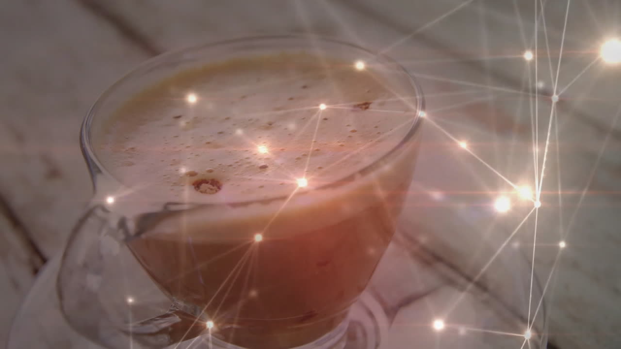 Glass coffee cup glowing with digital sparkles, embodying animated illustration for marketing