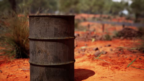 old empty rusted barrel on sand