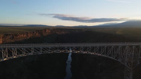 aerial view of a bridge over a canyon at sunset