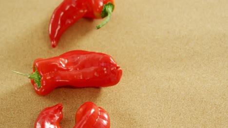 red chili pepper on brown background 4k