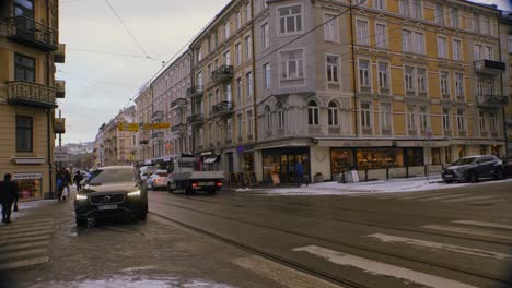 winter city street scene with an ambulance and other vehicles