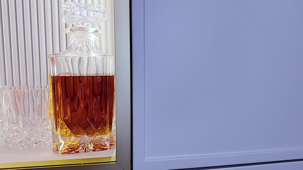 A bottle of whiskey in a luxurious cabinet, illuminated in gold.