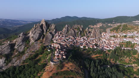 aerial drone of pietrapertosa, italy—mountain village built into rocky peaks, terracotta roofs, sweeping valley views. ideal for travel, tourism, culture, and cinematic landscape stock footage