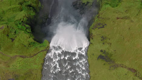 aerial: top down view of the famous skogafoss waterfall in iceland