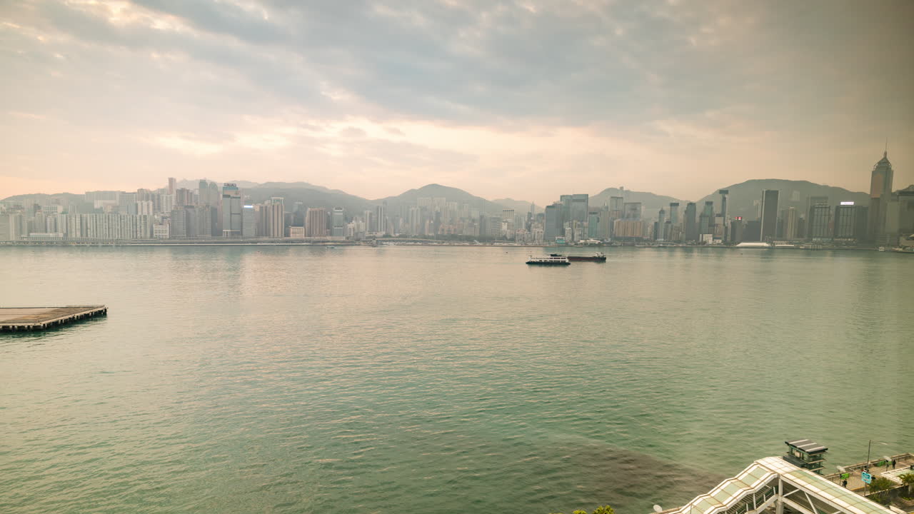 HONG KONG - 19 MARCH 2025 : Hong Kong Central skyline timelapse filmed from across the harbour in kowloon