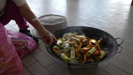 medium shot, ignite joss paper into flame