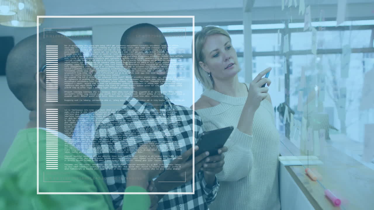 Three colleagues collaborating on business planning pointing at notes on glass wall using tablet