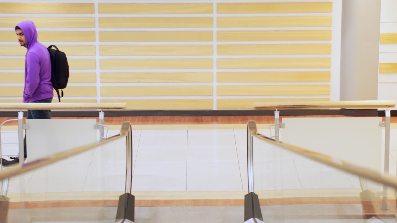 검은 배낭을 메고 지하철을 향해 걸어가는 캐주얼 남자, 위에서 보기