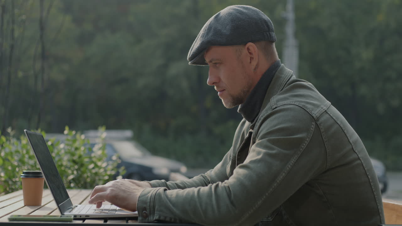 Man working on a laptop in a cafe