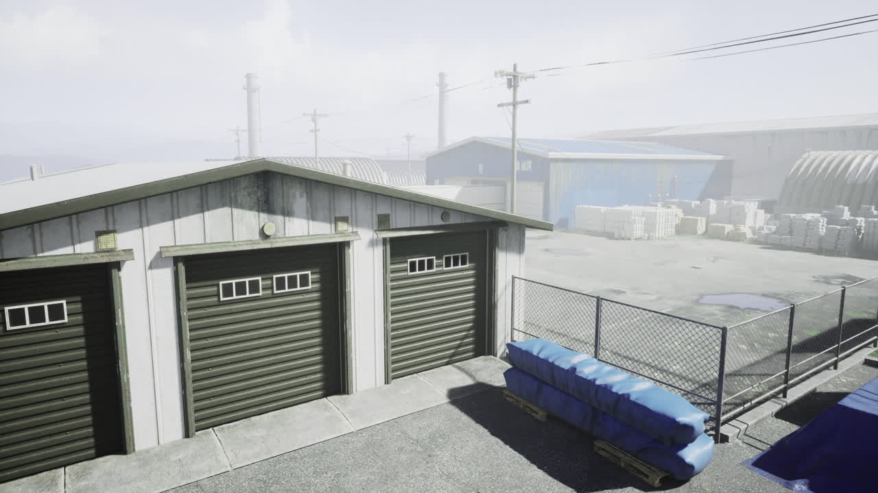 Industrial storage area with garages and stacked materials at noon