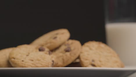 sliding shot approaching chocolate chip cookies on plate