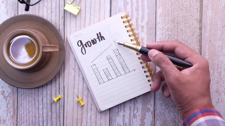 Hand writing growth chart in a notebook
