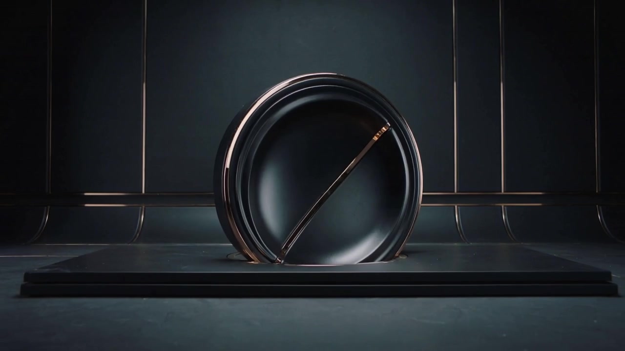 Pulling back camera, matte-black device rotating from cradle on stage, collar emerging to form disk