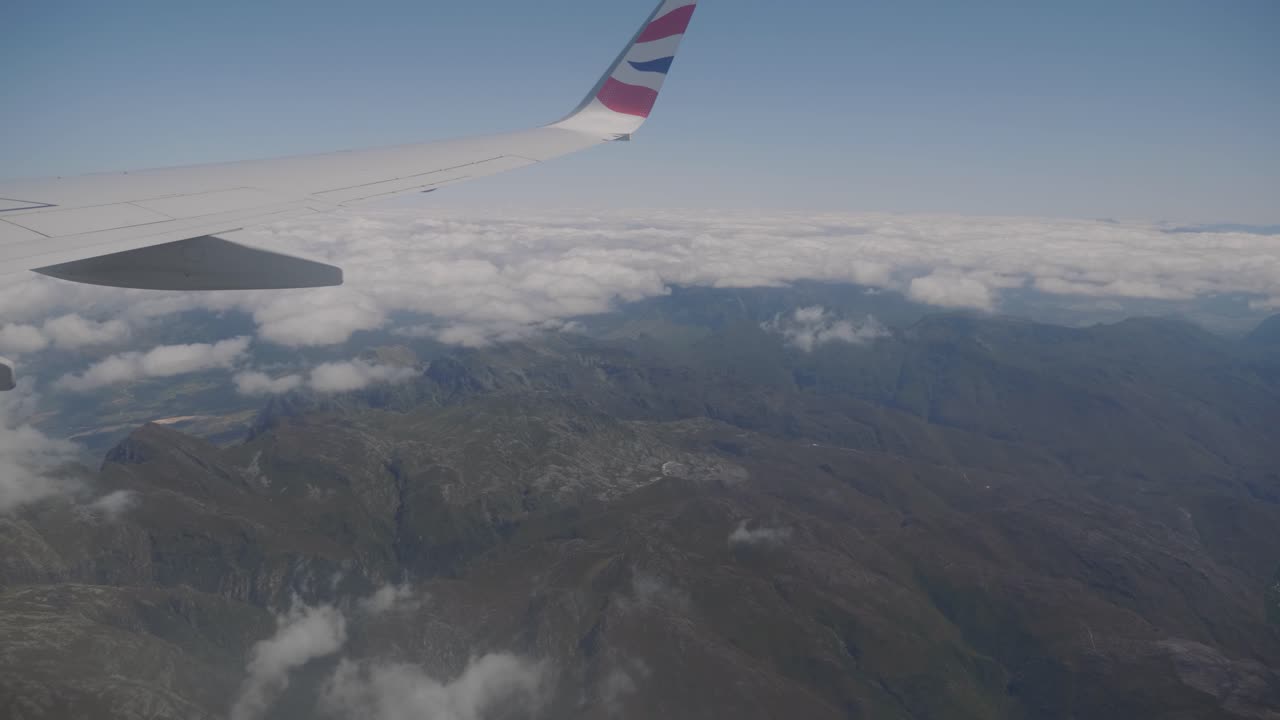 Spectacular view from airplane window overlooking the western cape with mountains and clouds in the background in South Africa.