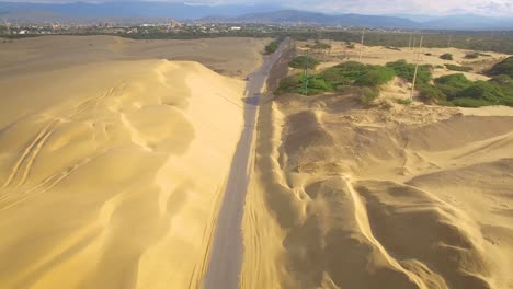 Aerial-view-of-the-road-across-Medanos-de-Coro-National-Park,-in-Falcon,-Venezuela