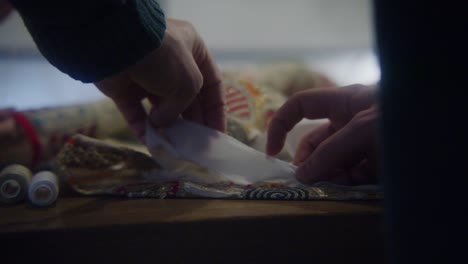 close up of hands working on fabric and textiles