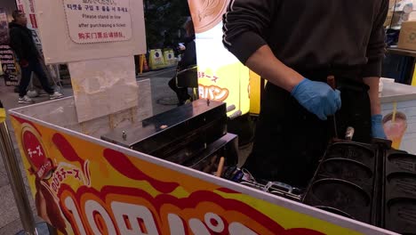 street vendor prepares cheese pancakes for customers.