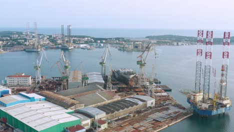 aerial arc shot circling around a shipyard off the coast of pula, croatia