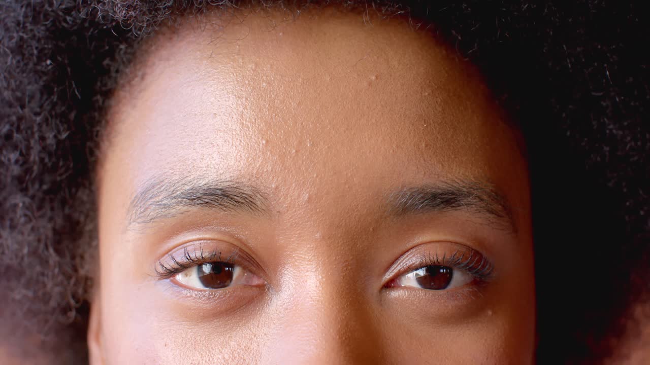 Portrait of happy eyes of african american woman at home, in slow motion