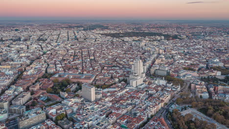 Aerial-panoramic-footage-of-large-city-in-sunset-time.-Hyperlapse-shot-of-city-centre-with-sights.-Madrid,-Spain