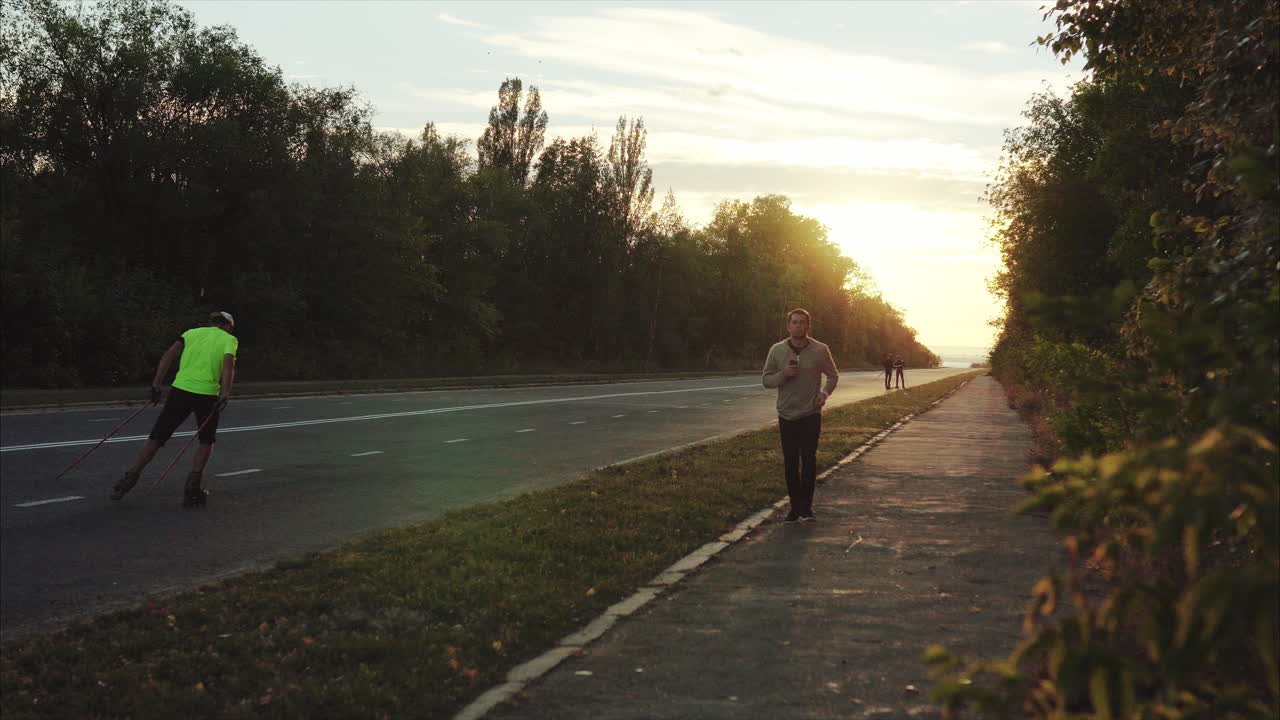 Man walking on a sidewalk at sunset