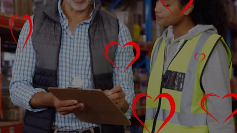 animation of red heart icons over caucasian male supervisor and female worker checking stock