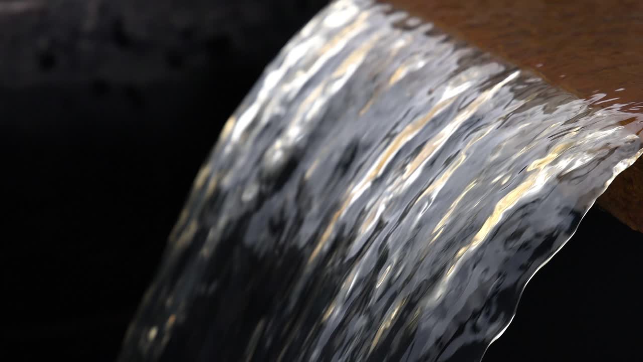 Acqua che scorre a cascata su un bordo di legno