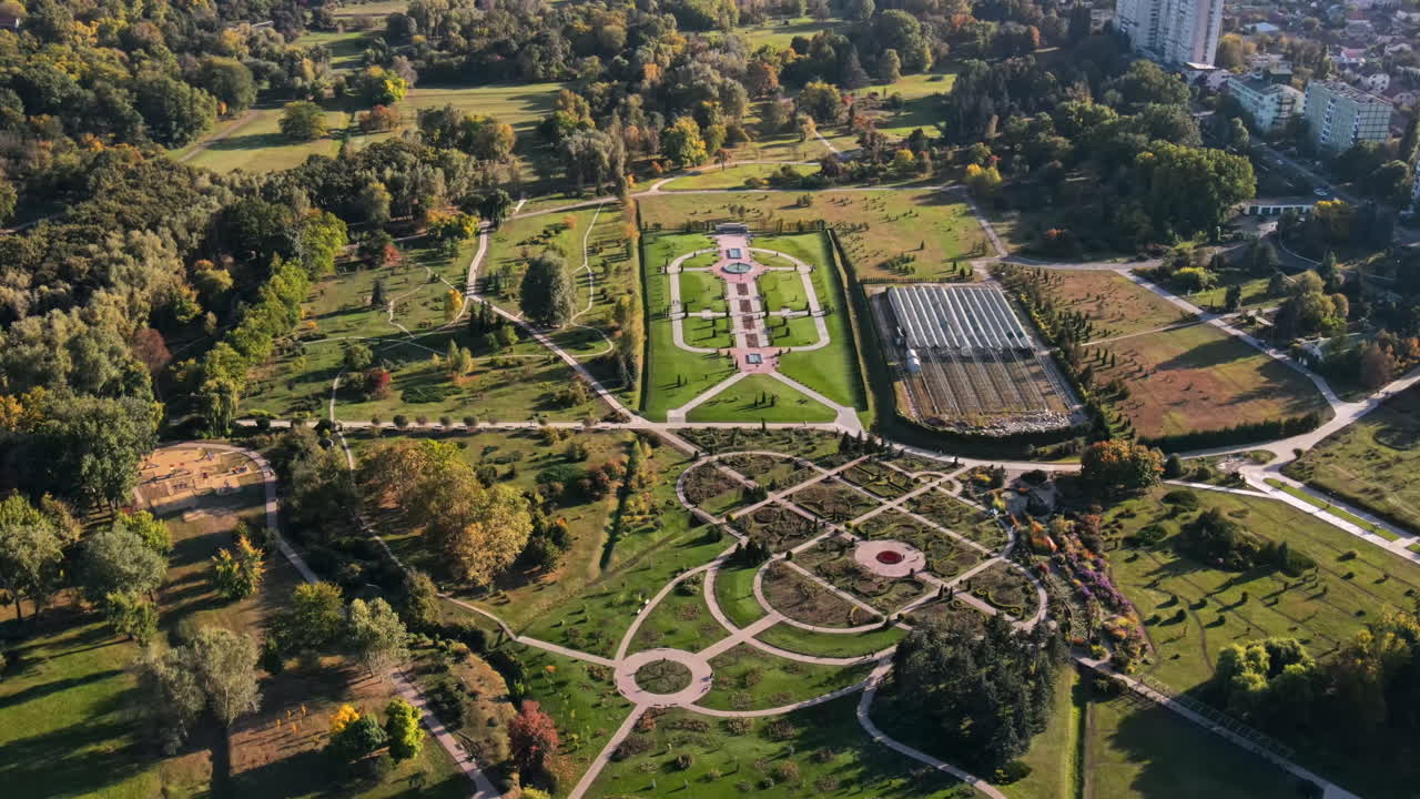 Aerial drone view of Chisinau at sunset. Panorama view of a park with lush trees and lake. Moldova